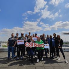 15 attendees of IWC Düsseldorf on roof terrace of CGI with cityscape behind